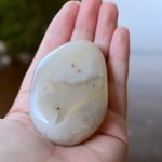 large polished rock in persons hand