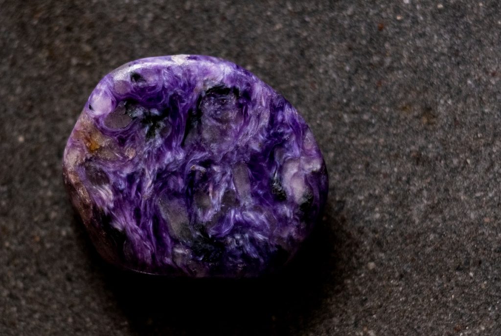 purple Charoite specimen on dark background