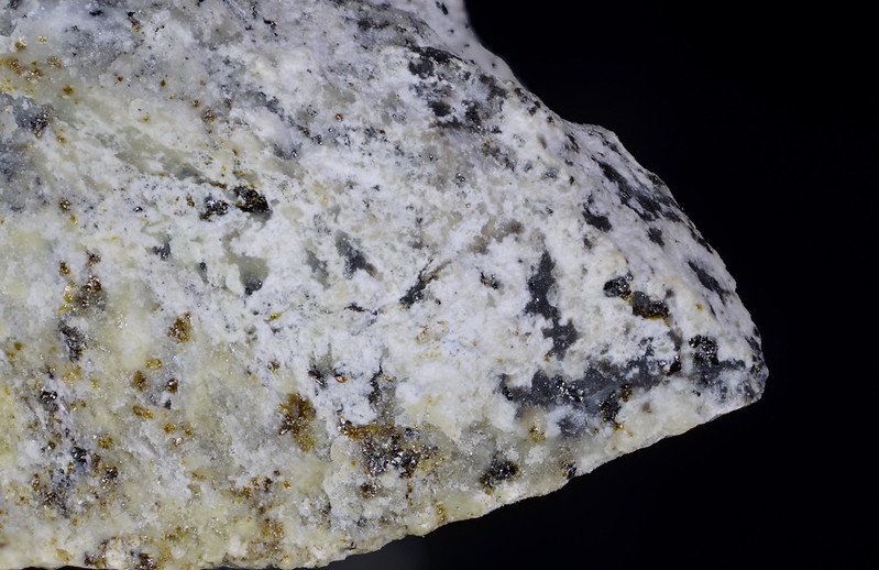 Fukalite mineral on dark background